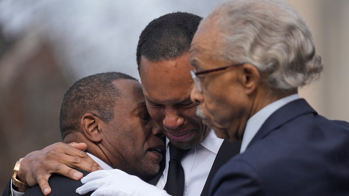 Al Sharpton standing with Yusef Jackson's family and offering support.