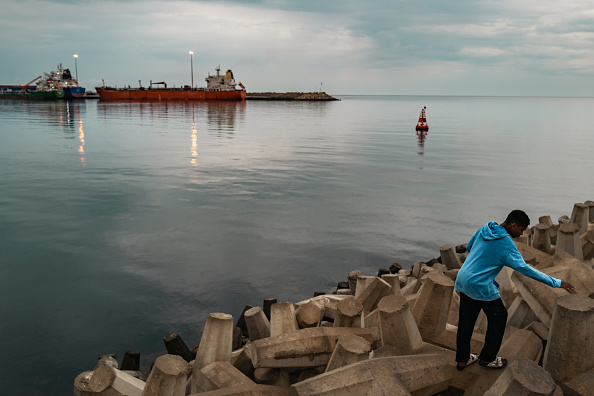 A bulk carrier sits anchored at Sultan Qaboos Port in Muscat, Oman