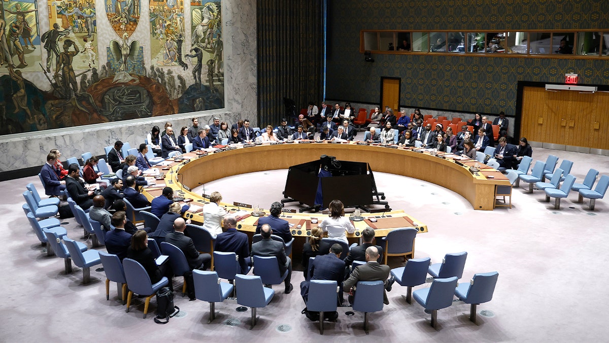 Diplomats gather around the chamber table during a United Nations Security Council meeting in New York.