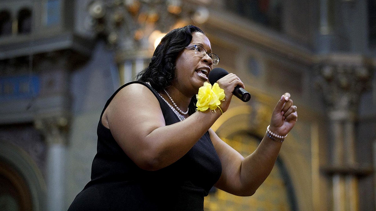 Chicago City Treasurer Melissa Conyears-Ervin speaks into microphone at an event.