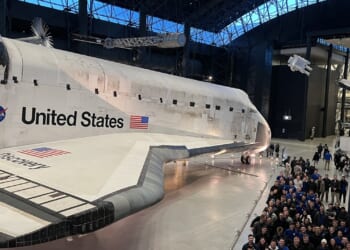 A group of Air Force cadets visiting the Discovery space shuttle.