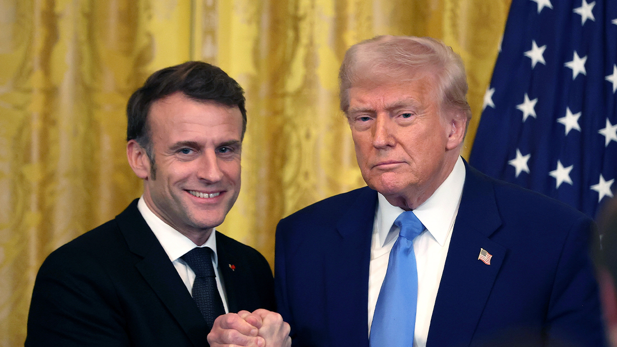 Macron shakes hands with Trump