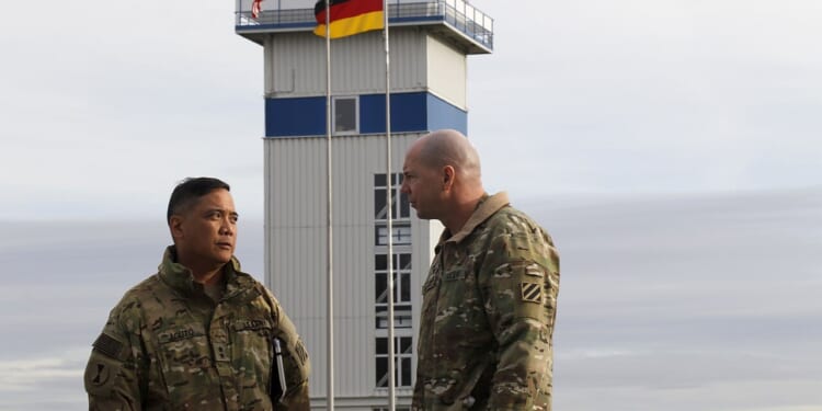 Two US Army officers speaking at a base in Germany.