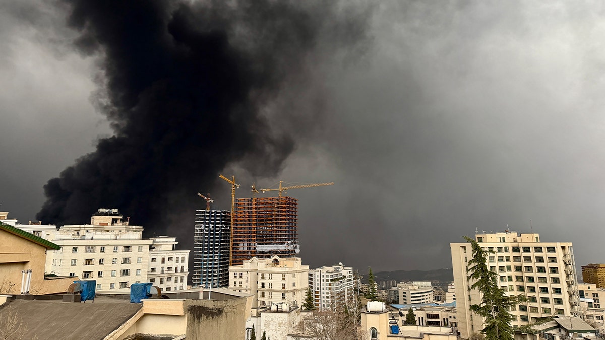 Smoke billows after airstrikes on oil depots in Tehran, Iran.