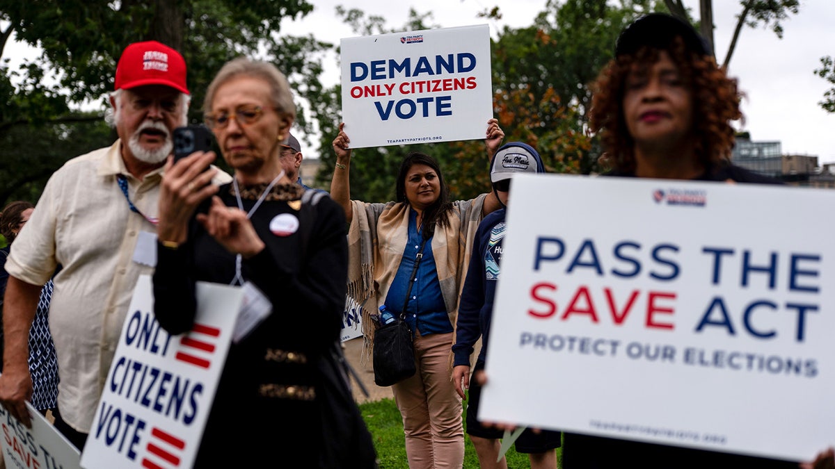 SAVE Act supporters holding signs