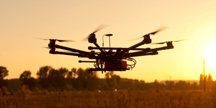 A drone in flight at sunset.