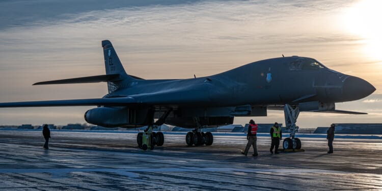 A B-1 Lancer on a runway at dawn.