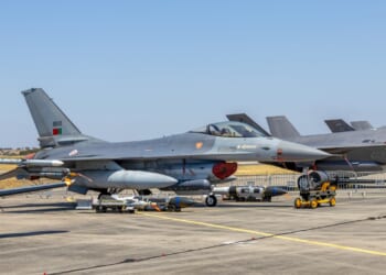 A Portuguese F-16 fighter jet on the tarmac at an airshow.