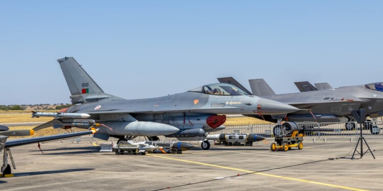 A Portuguese F-16 fighter jet on the tarmac at an airshow.