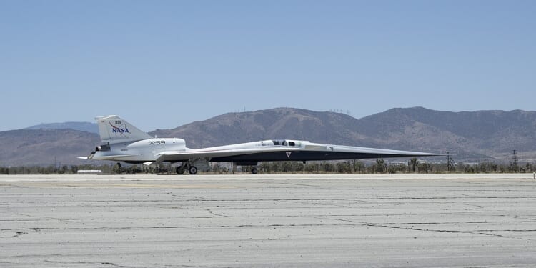 The X-59 experimental plane on the tarmac at an airport.
