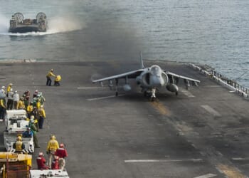 An AV-8B Harrier II aircraft on the deck of an amphibious assault ship.
