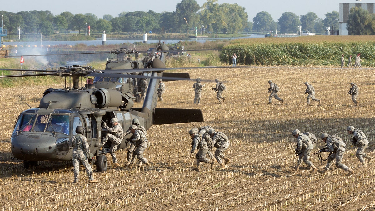 82 Airborne Div. soldiers enter Blackhawk helicopters at the Operation Market Garden memorial.
