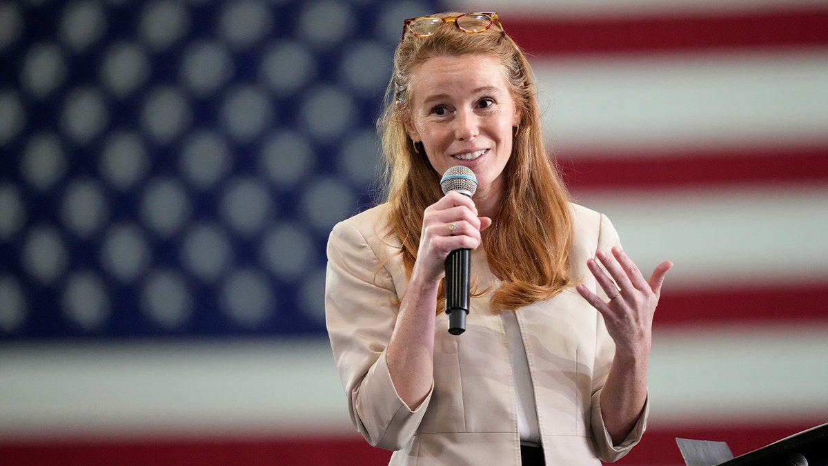 Rebecca Cooke, candidate for Congress in Wisconsin's Third Congressional District, speaks during a town hall hosted by Pete Buttigieg at the La Crosse Center on January 16, 2026 in La Crosse, Wisconsin. Cooke spoke about issues facing families, farms, and communities in western Wisconsin.