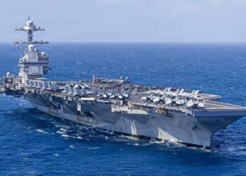 The USS Gerald R. Ford at sea on a clear day.