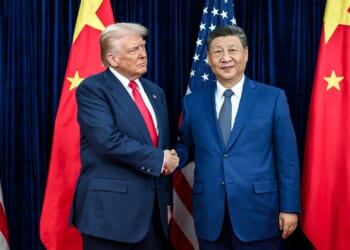 Donald Trump and Xi Jinping shaking hands at a summit in Busan, South Korea.
