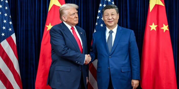 Donald Trump and Xi Jinping shaking hands at a summit in Busan, South Korea.