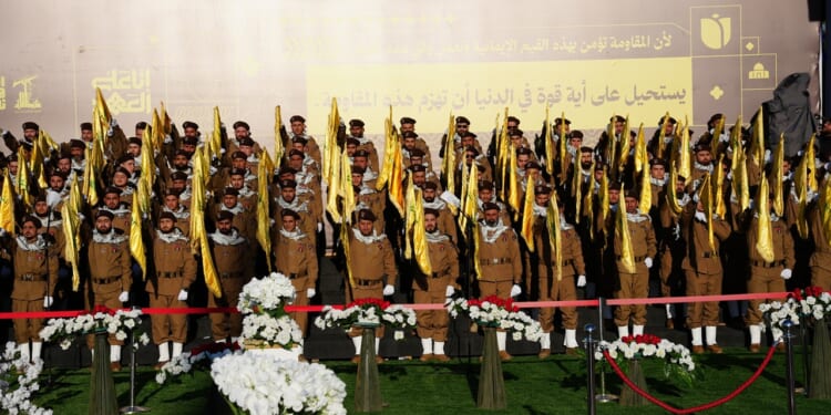 A group of uniformed Hezbollah fighters at a funeral.