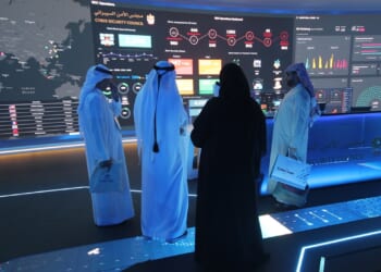 A group of officials study a data display in Dubai, UAE.