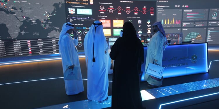A group of officials study a data display in Dubai, UAE.