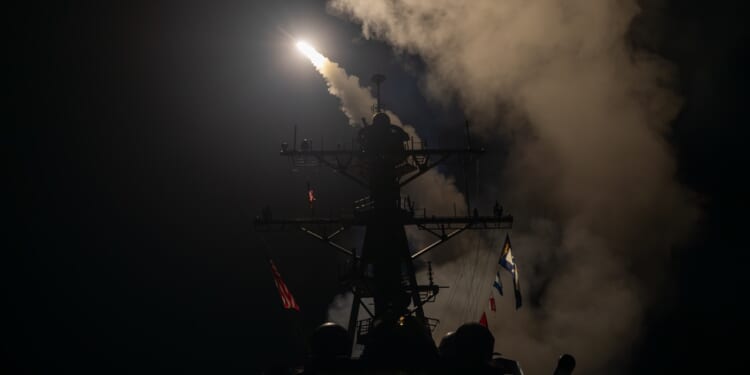 An Arleigh Burke-class destroyer fires a Tomahawk missile.