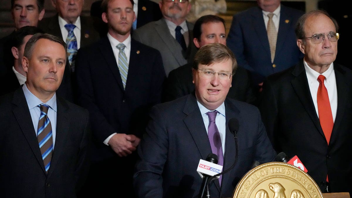 Mississippi Gov. Tate Reeves speaking at the Mississippi Capitol in Jackson with Lt. Gov. Delbert Hosemann and Jason White