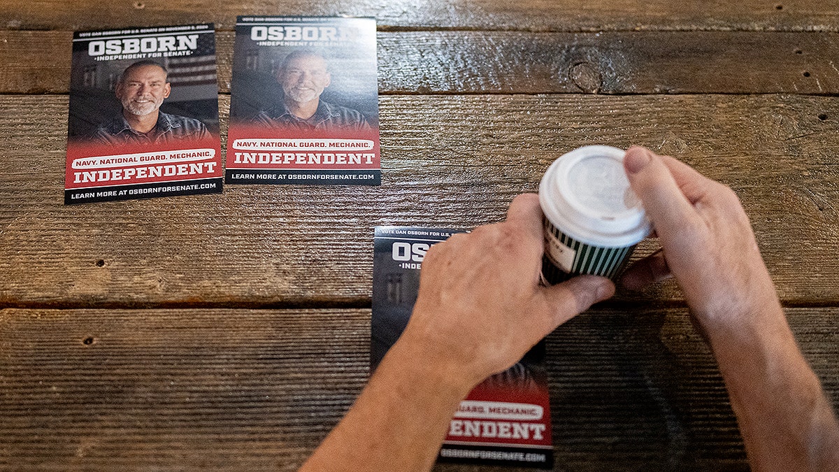 Placards on a table promoting U.S. Senate candidate Dan Osborn