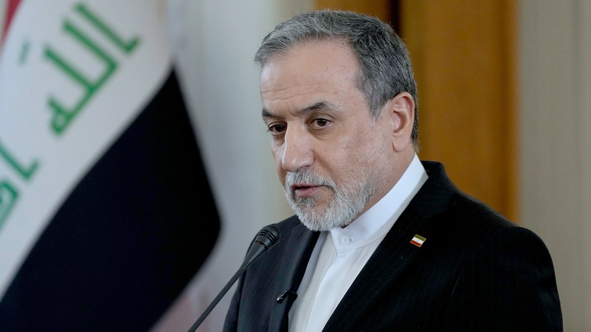 Iranian Foreign Minister Abbas Araghchi addresses reporters beside Iraq’s foreign minister during talks in Tehran.