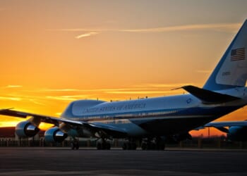 Air Force One on a runway at dusk.