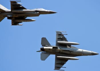 Two F-16 fighter jets in flight.