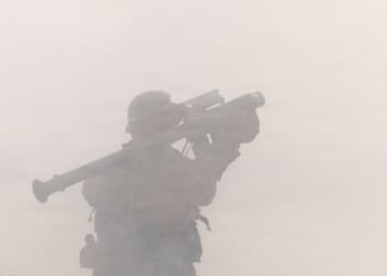 A soldier firing a MANPADS launcher.
