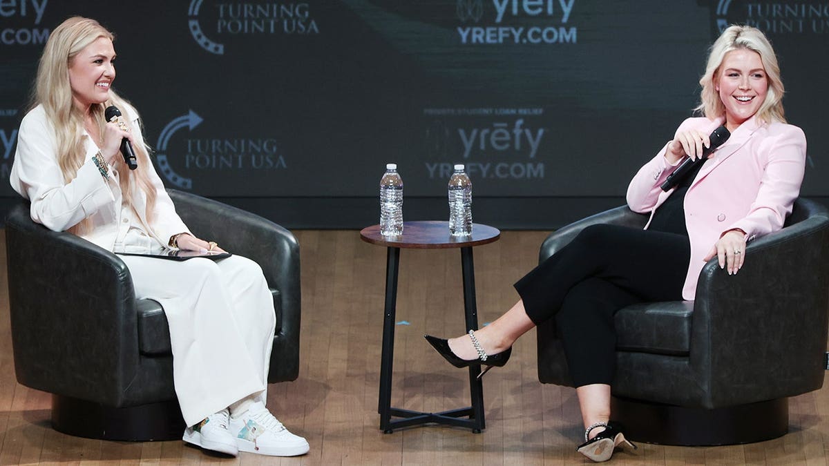 Erika Kirk speaking with Karoline Leavitt at a Turning Point USA event in Washington, D.C.