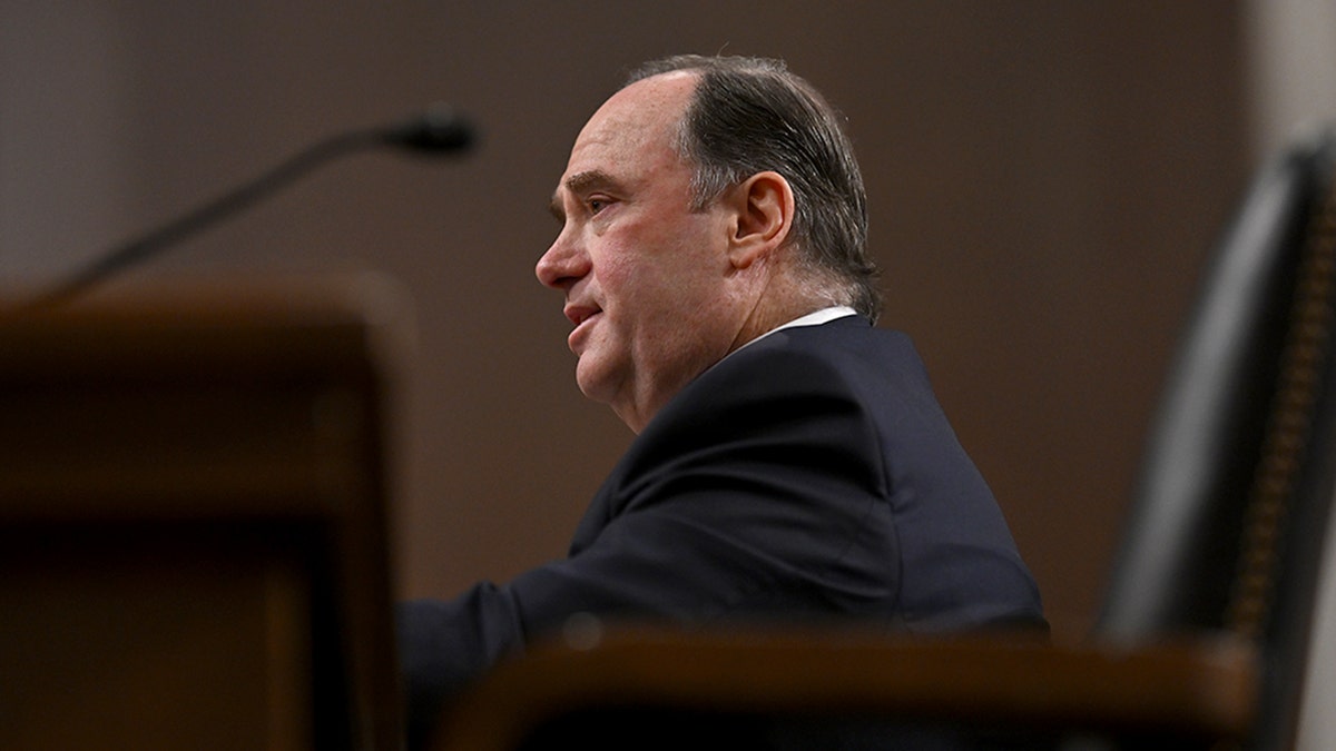 John Phelan seated testifying before the Senate.