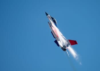 An F-16 Fighting Falcon demonstrator aircraft in flight.