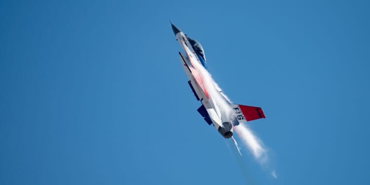 An F-16 Fighting Falcon demonstrator aircraft in flight.