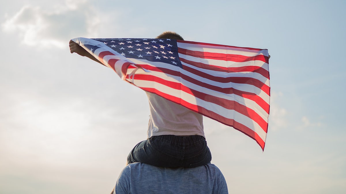 Little boy holding American flag