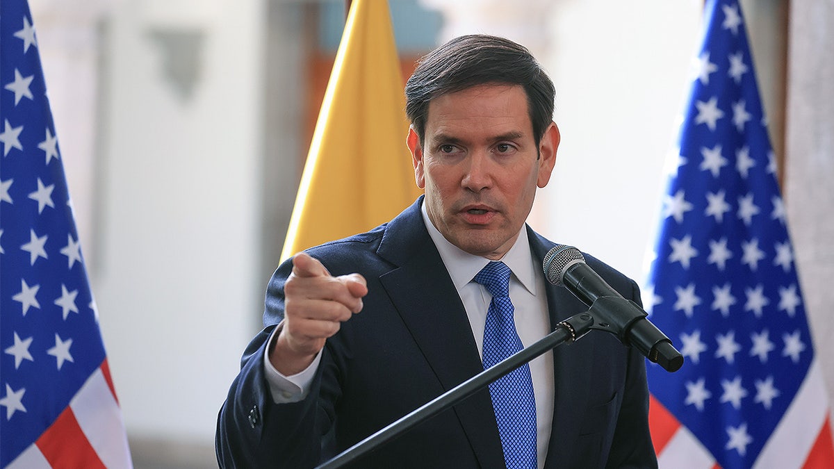 Secretary of State Marco Rubio standing in front of a U.S. State Department backdrop.