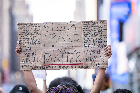 A protester holds a sign that says, 