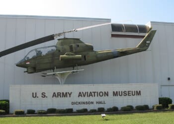 The front of the US Army Aviation Museum, featuring a helicopter on display.