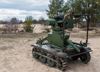 A military robot on a beach.